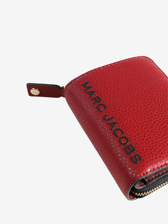 Close up of red wallet, showing texture of the split cow leather fabric