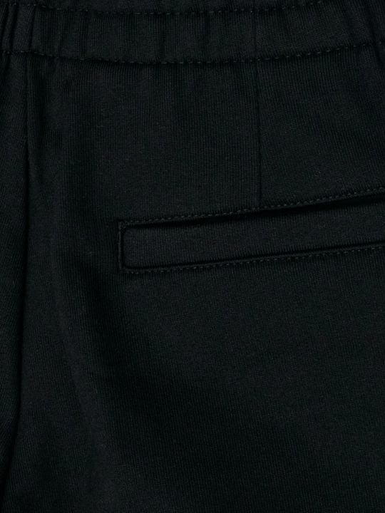 Close up of black pant, showing texture of the Cotton fabric