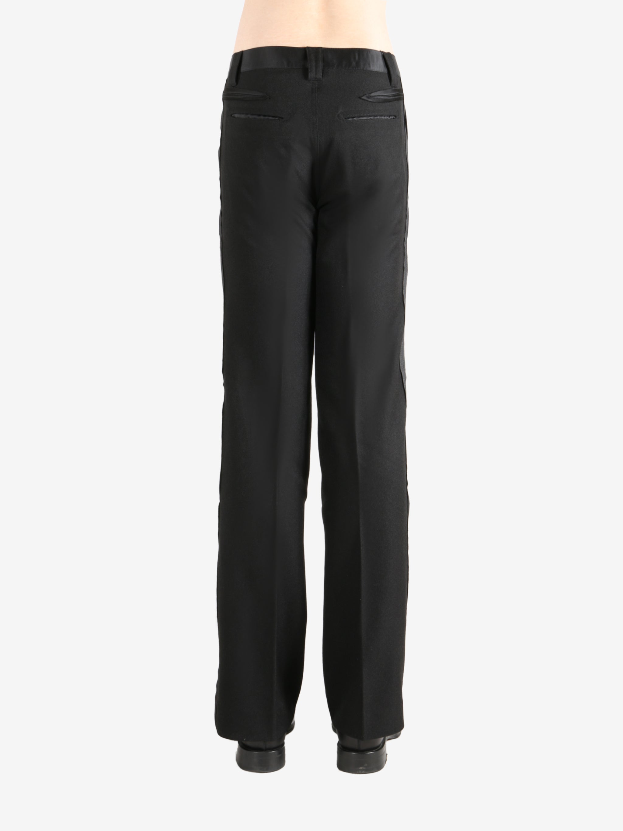 Black trouser worn by a person, showing the trouser's fit