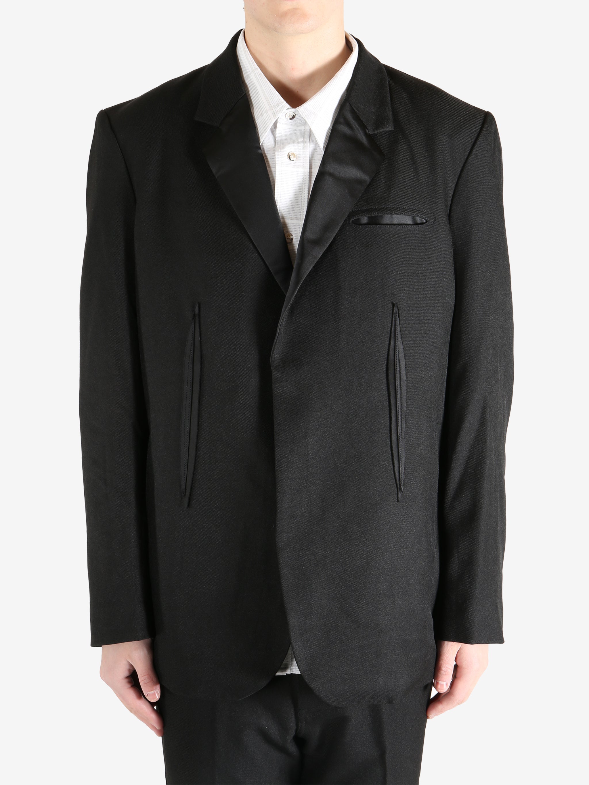 Black blazer worn by a person, showing the blazer's fit