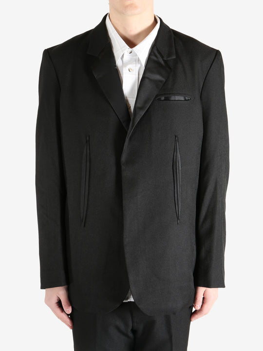 Black blazer worn by a person, showing the blazer's fit