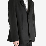 Black blazer worn by a person, showing the blazer's fit