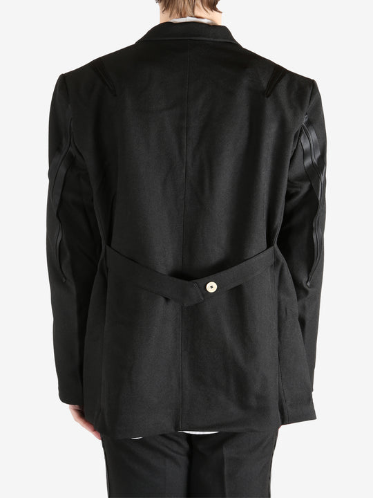 Black blazer worn by a person, showing the blazer's fit