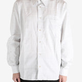 White shirt worn by a person, showing the shirt's fit