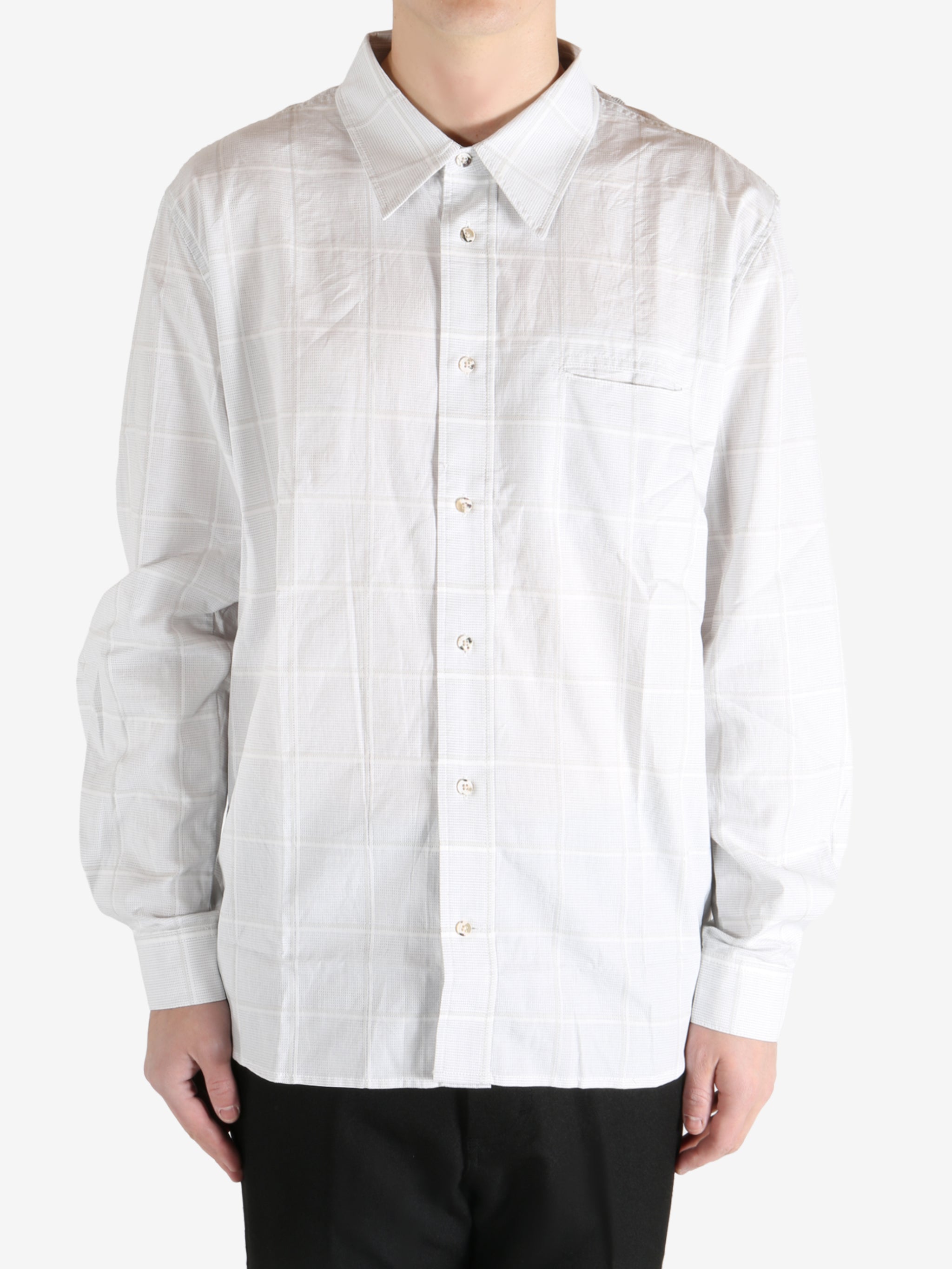 White shirt worn by a person, showing the shirt's fit