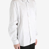 White shirt worn by a person, showing the shirt's fit
