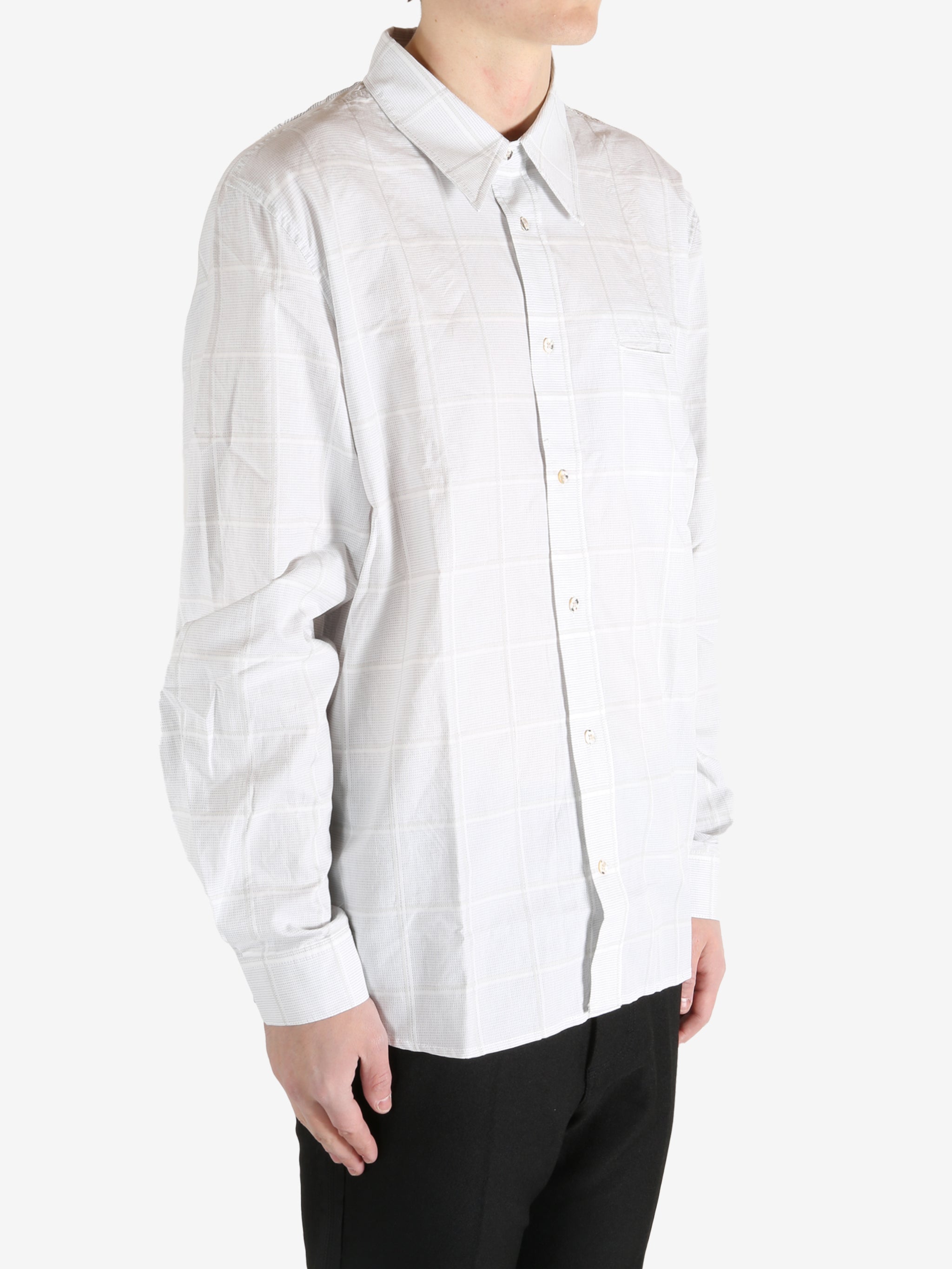 White shirt worn by a person, showing the shirt's fit
