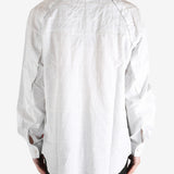 White shirt worn by a person, showing the shirt's fit