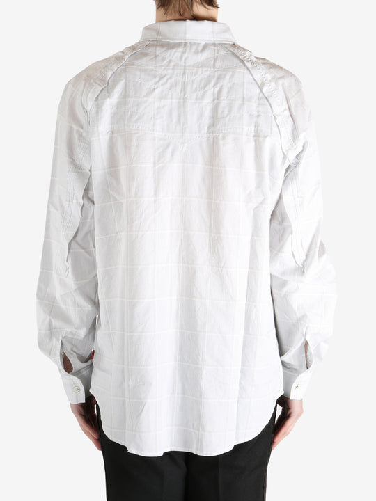 White shirt worn by a person, showing the shirt's fit
