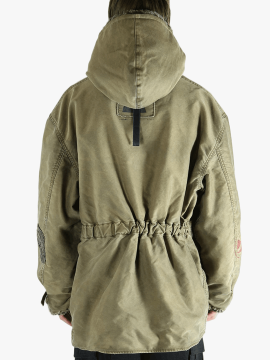 Green jackets-coats worn by a person, showing the cotton fit