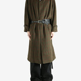 Green coat worn by a person, showing the coat fit