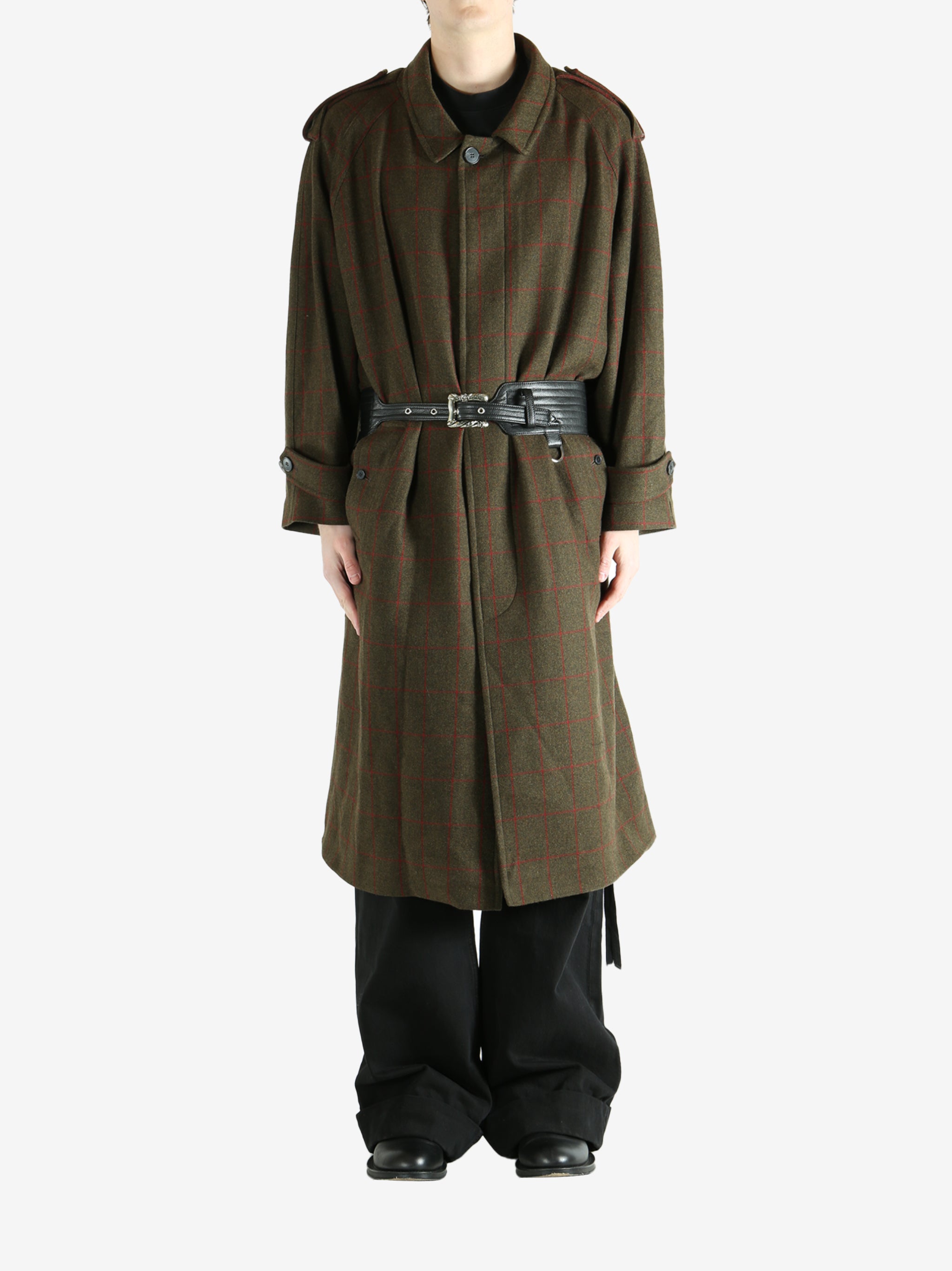 Green coat worn by a person, showing the coat fit