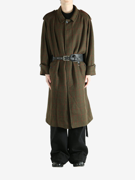 Green coat worn by a person, showing the coat fit