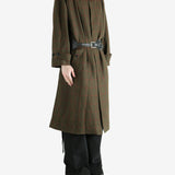 Green coat worn by a person, showing the coat fit