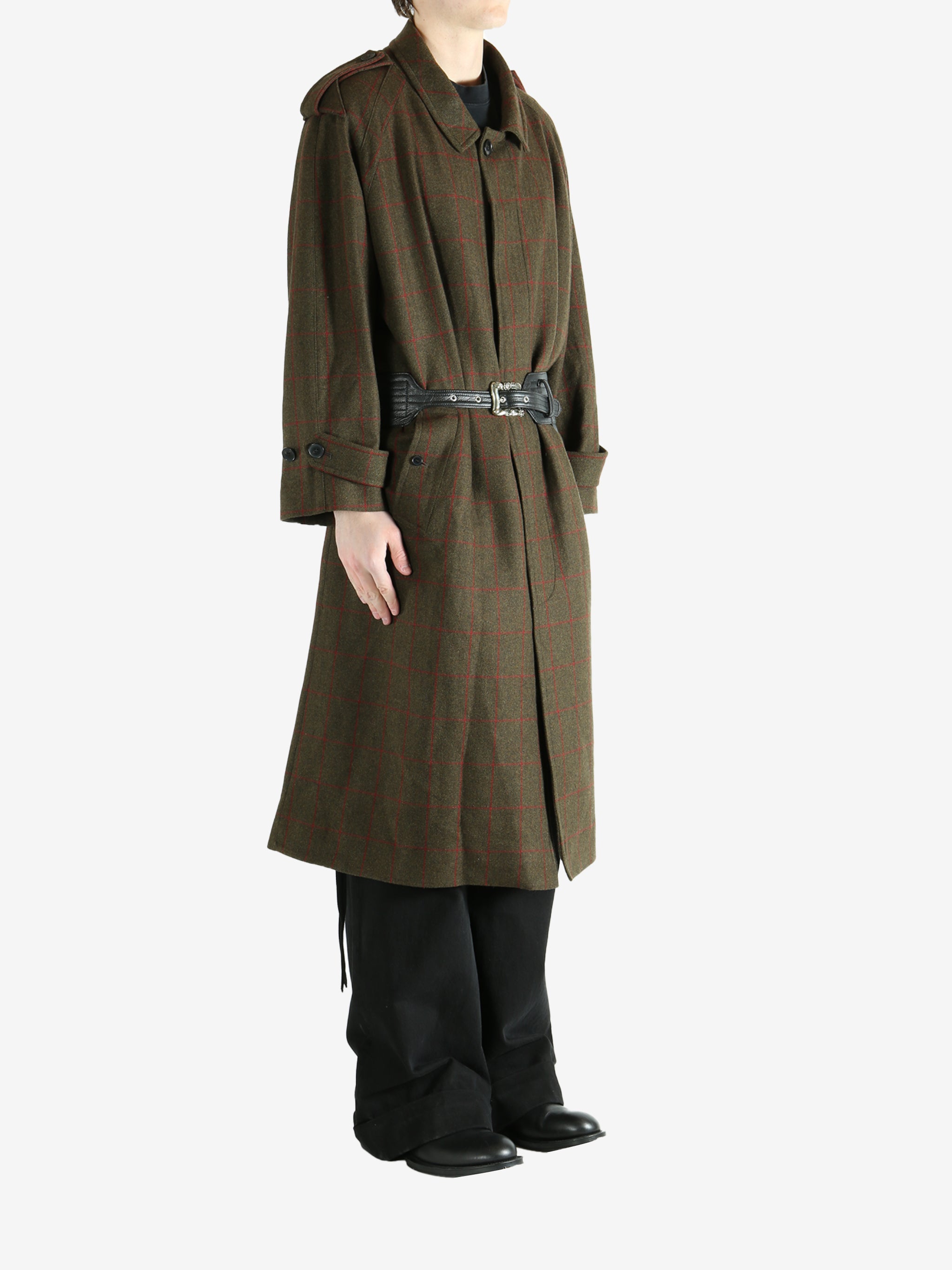 Green coat worn by a person, showing the coat fit