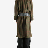 Green coat worn by a person, showing the coat fit