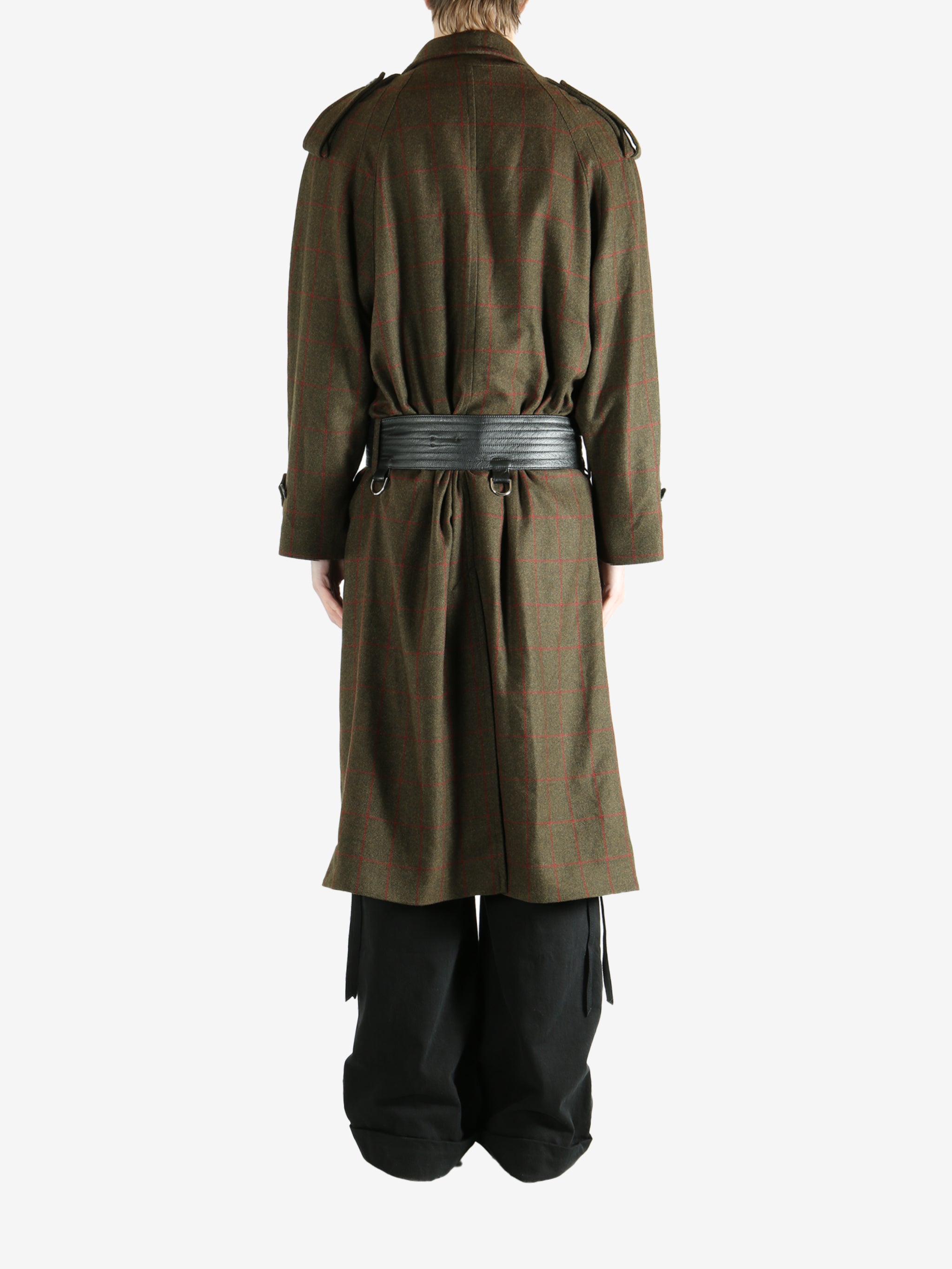 Green coat worn by a person, showing the coat fit