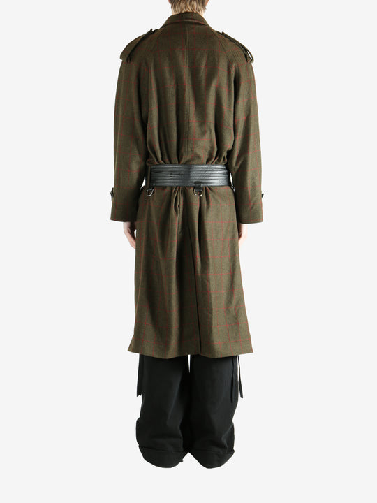 Green coat worn by a person, showing the coat fit