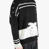 Black knitwear worn by a person, showing the cotton fit