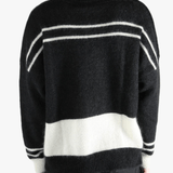 Black knitwear worn by a person, showing the cotton fit