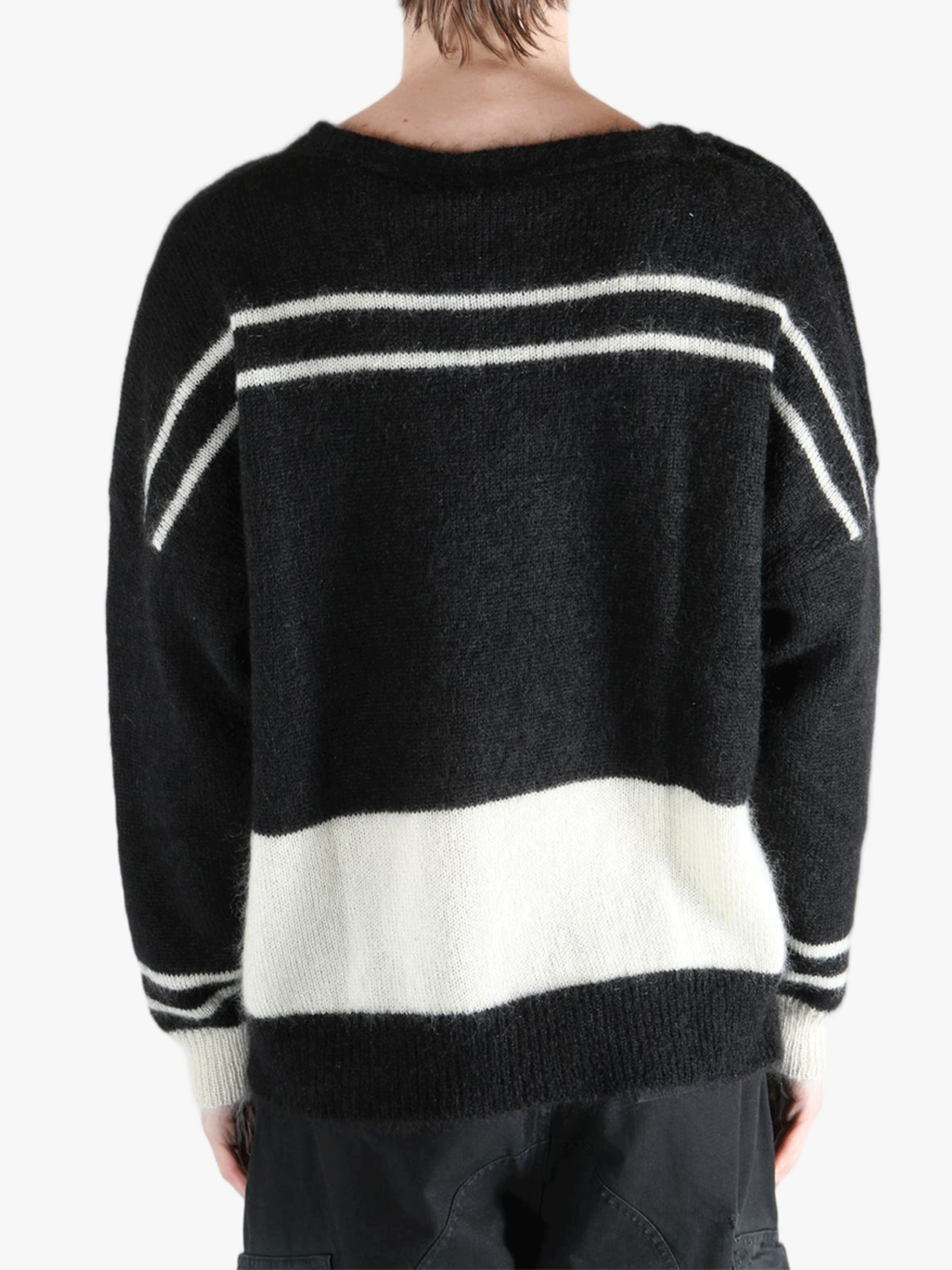 Black knitwear worn by a person, showing the cotton fit