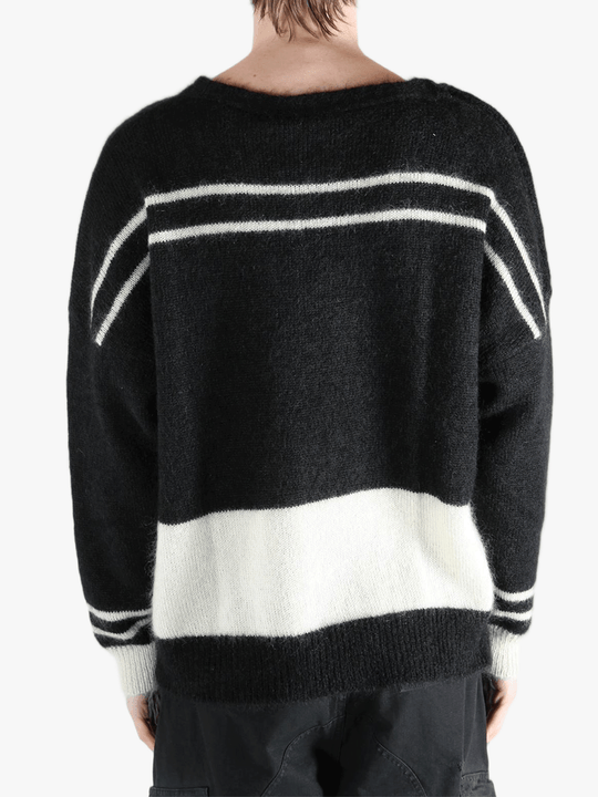 Black knitwear worn by a person, showing the cotton fit