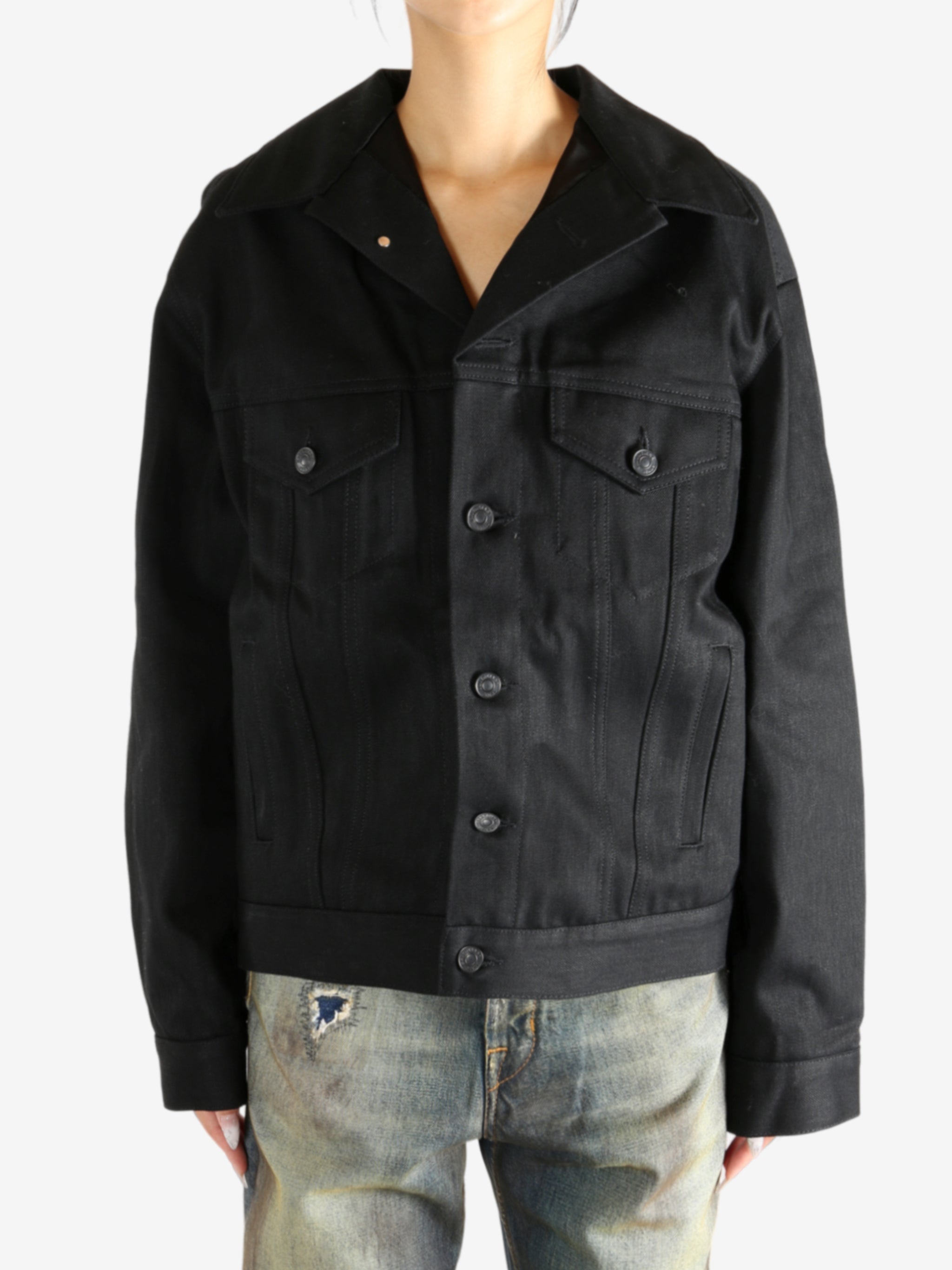 black jacket worn by a person, showing the jacket fit