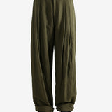 Green pants worn by a person, showing the pants fit