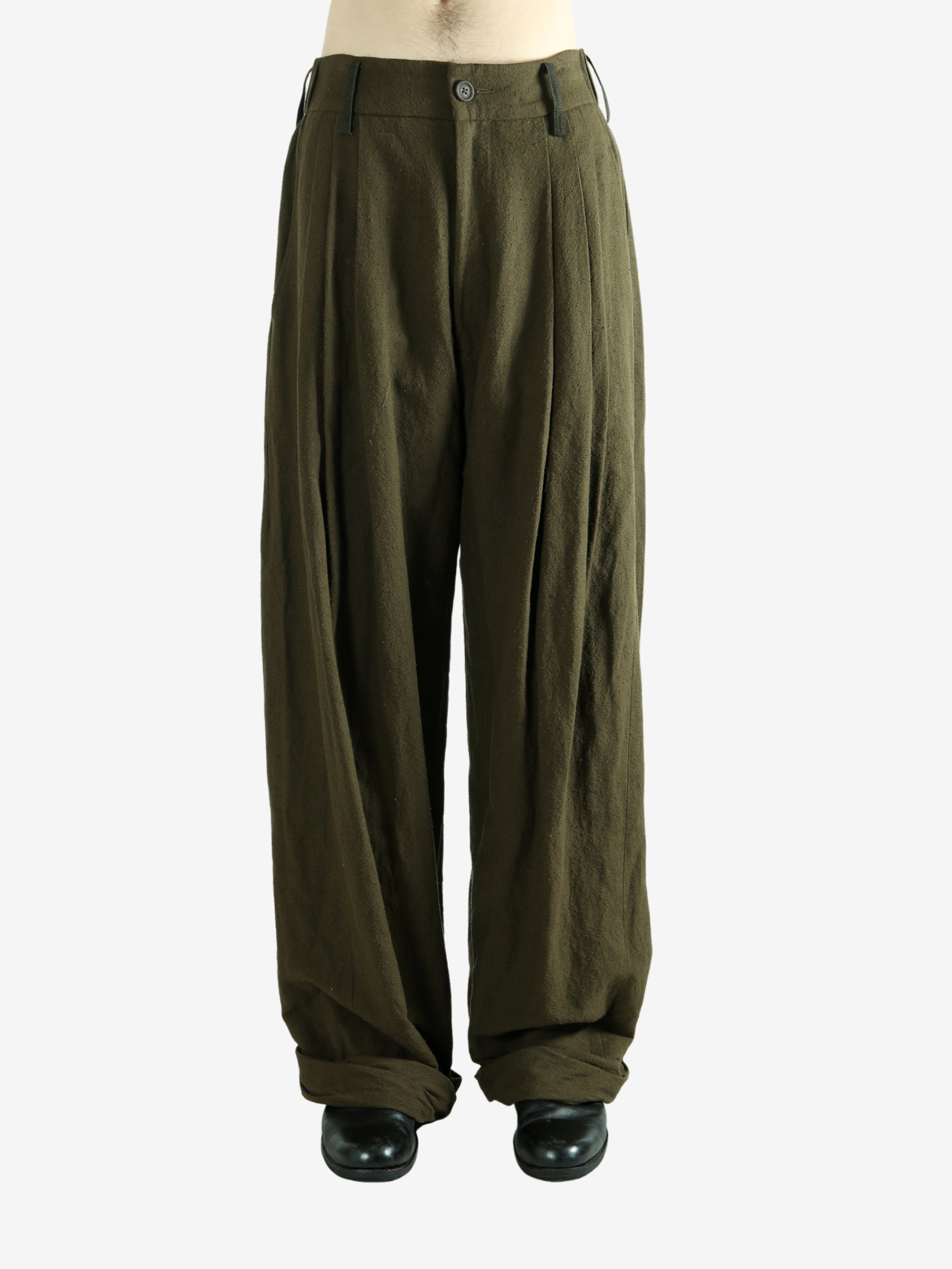 Green pants worn by a person, showing the pants fit