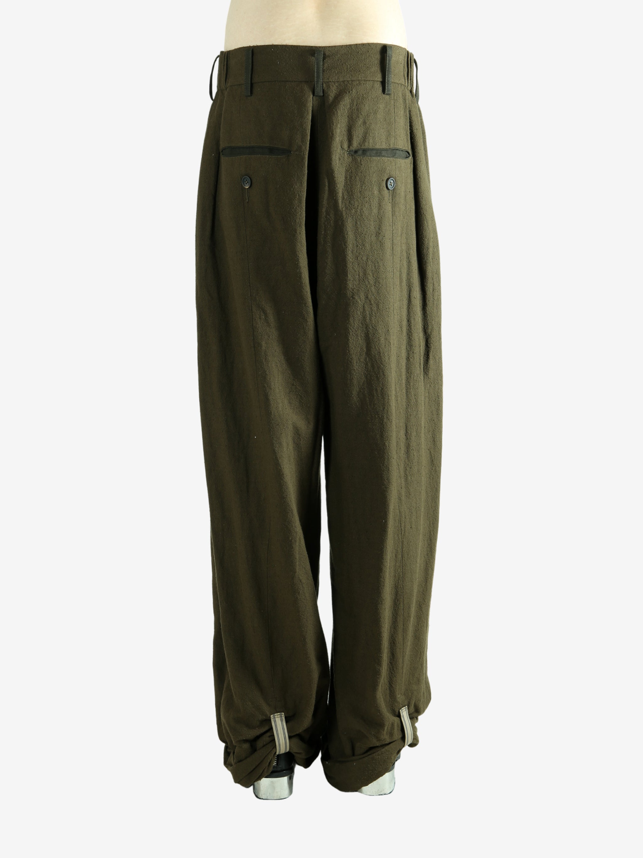 Green pants worn by a person, showing the pants fit