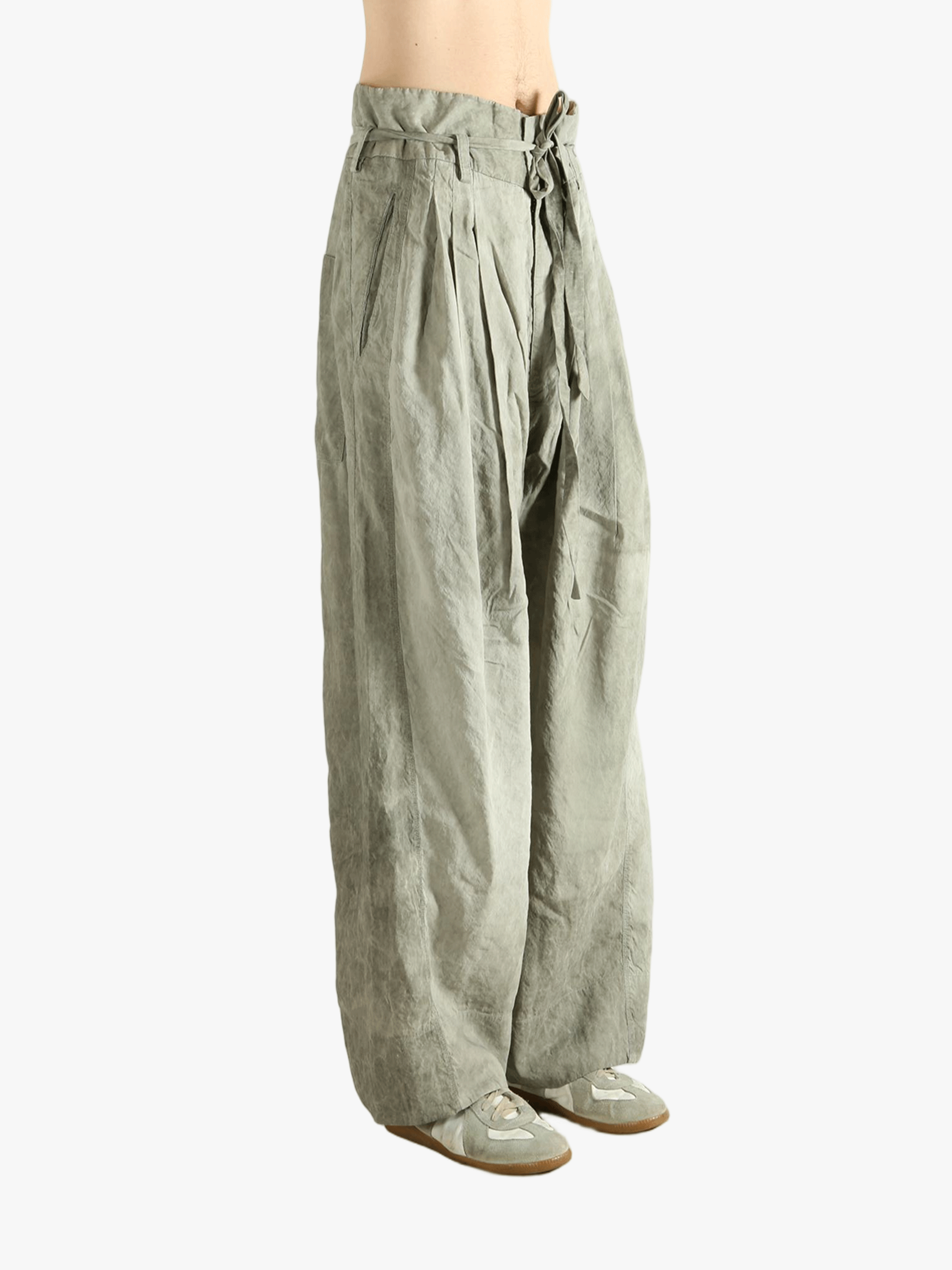 Light green wide-leg pants worn by a person, showing the pants fit