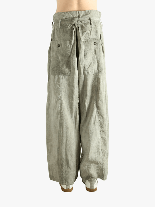 Light green wide-leg pants worn by a person, showing the pants fit