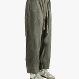 Green baggy pants worn by a person,showing the pants fit