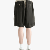 Black shorts worn by a person, showing the shorts's fit