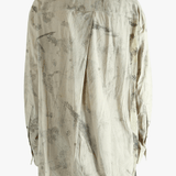 Grey shirt worn by a person, showing the shirt's fit