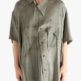 Green shirt worn by a person, showing the shirt's fit