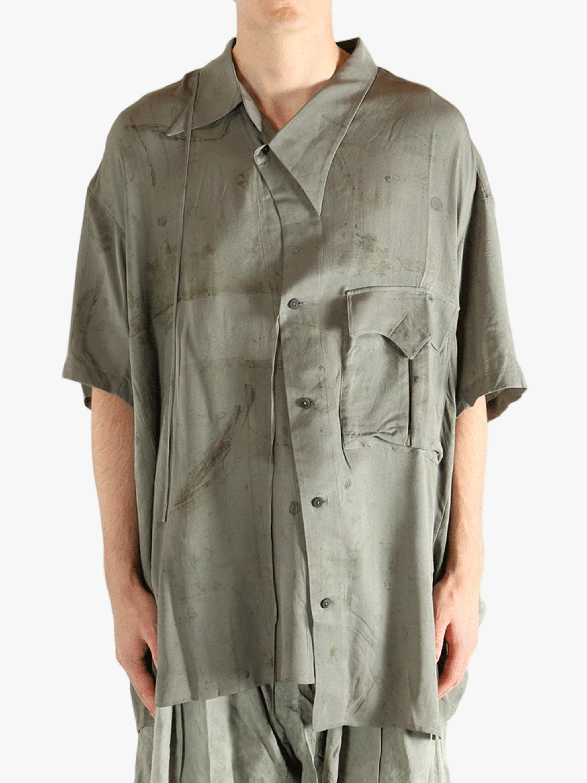 Green shirt worn by a person, showing the shirt's fit