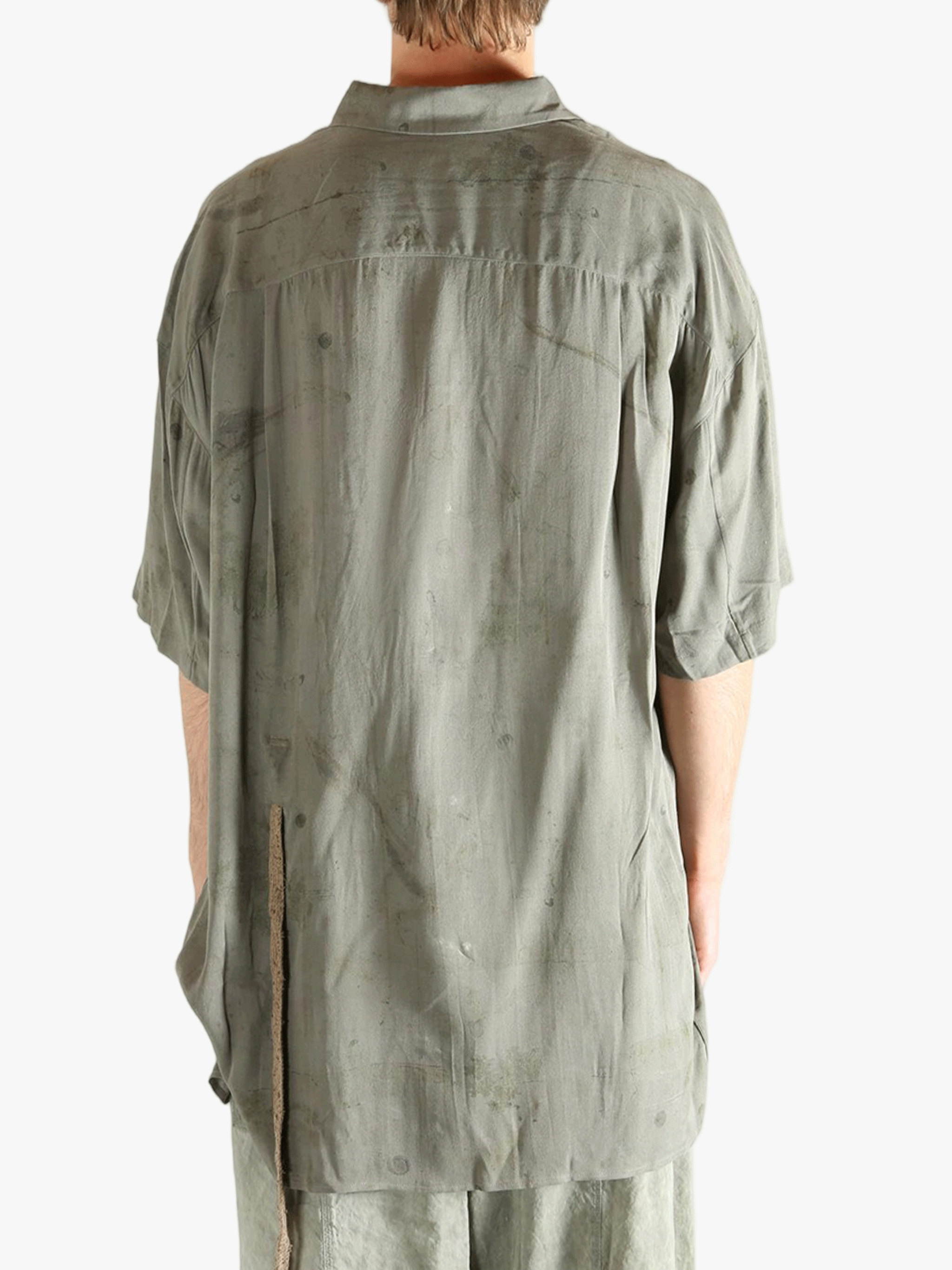 Green shirt worn by a person, showing the shirt's fit
