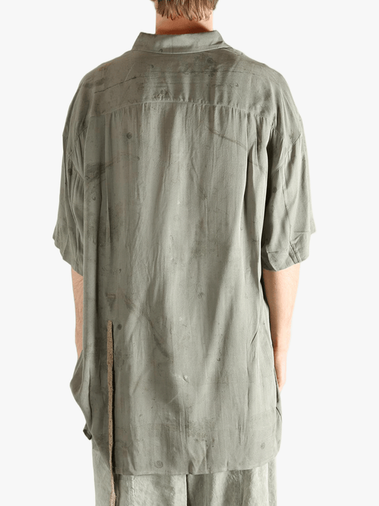 Green shirt worn by a person, showing the shirt's fit