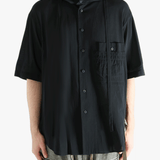 Black shirt worn by a person, showing the shirt's fit