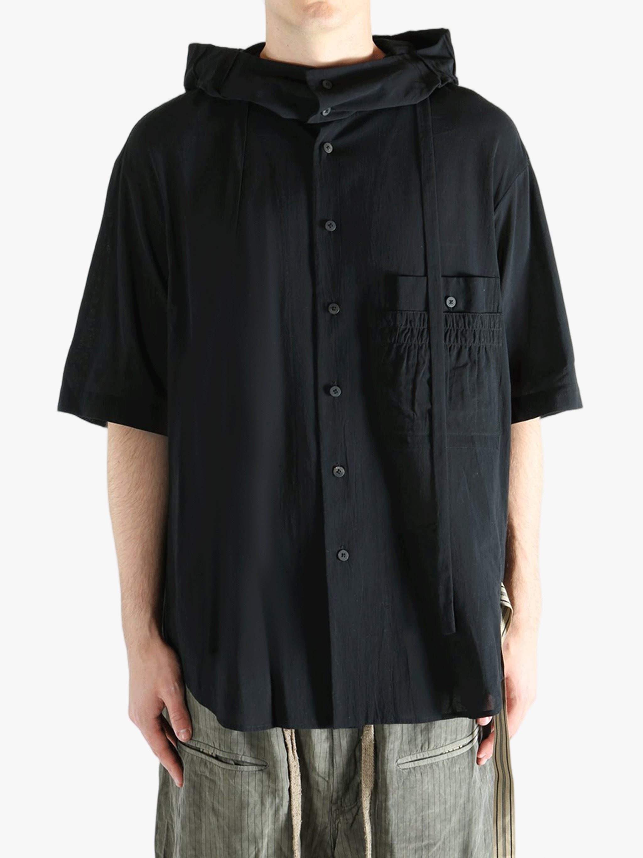 Black shirt worn by a person, showing the shirt's fit