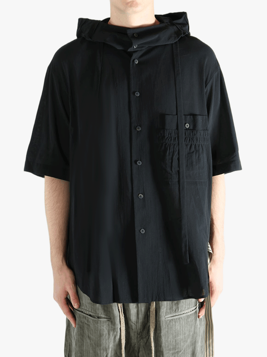 Black shirt worn by a person, showing the shirt's fit