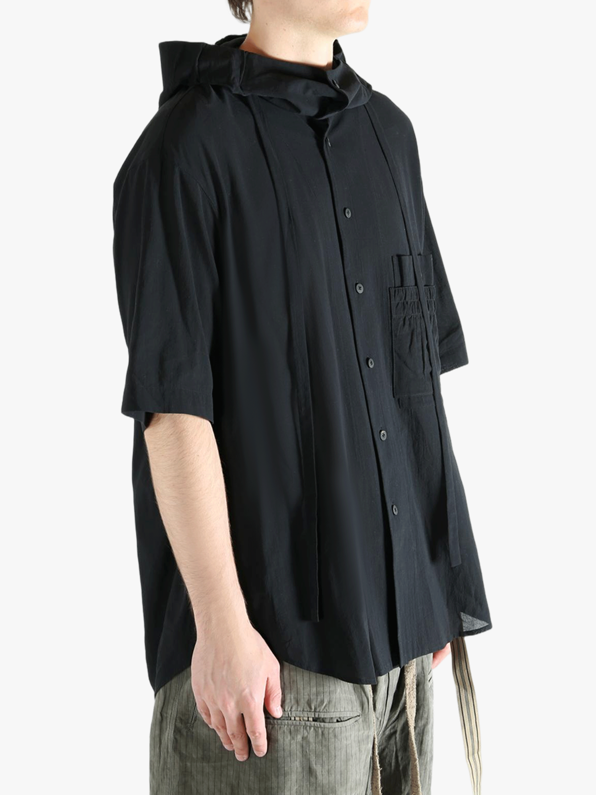 Black shirt worn by a person, showing the shirt's fit