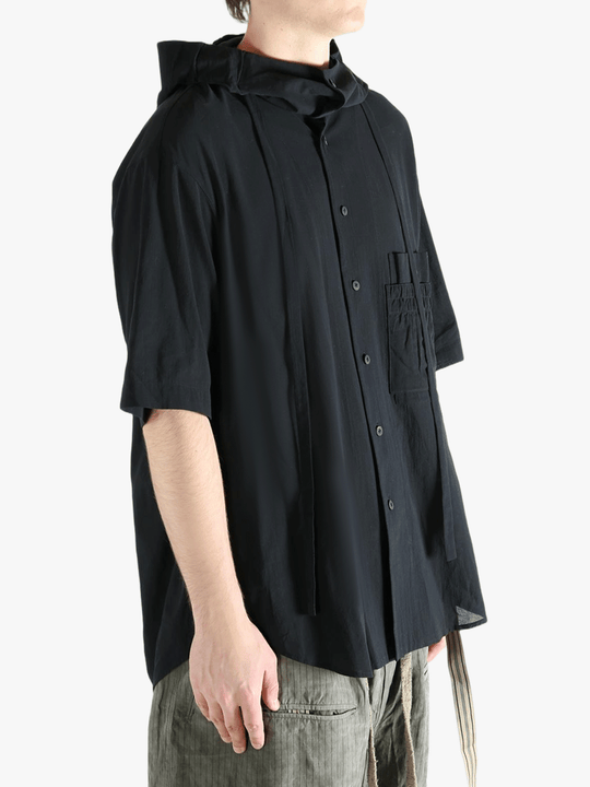 Black shirt worn by a person, showing the shirt's fit