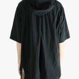 Black shirt worn by a person, showing the shirt's fit