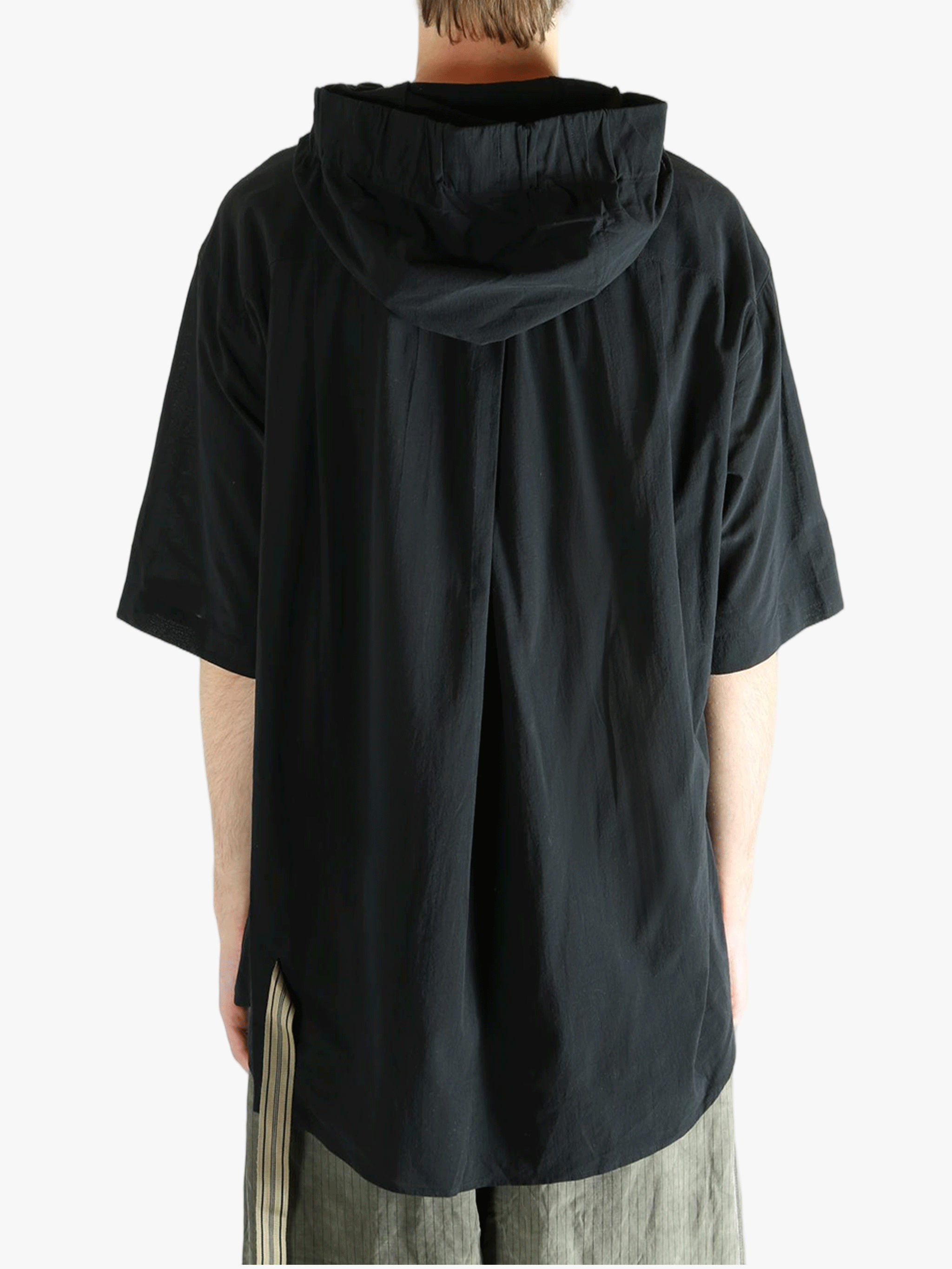 Black shirt worn by a person, showing the shirt's fit