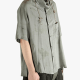 Grey shirt worn by a person, showing the shirt's fit