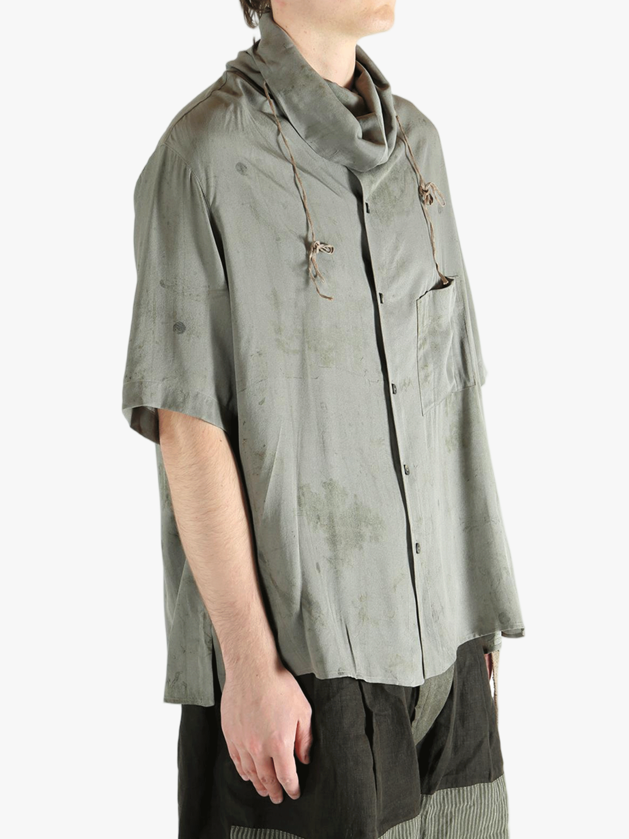 Grey shirt worn by a person, showing the shirt's fit