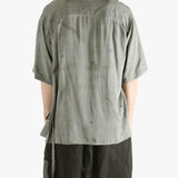 Grey shirt worn by a person, showing the shirt's fit
