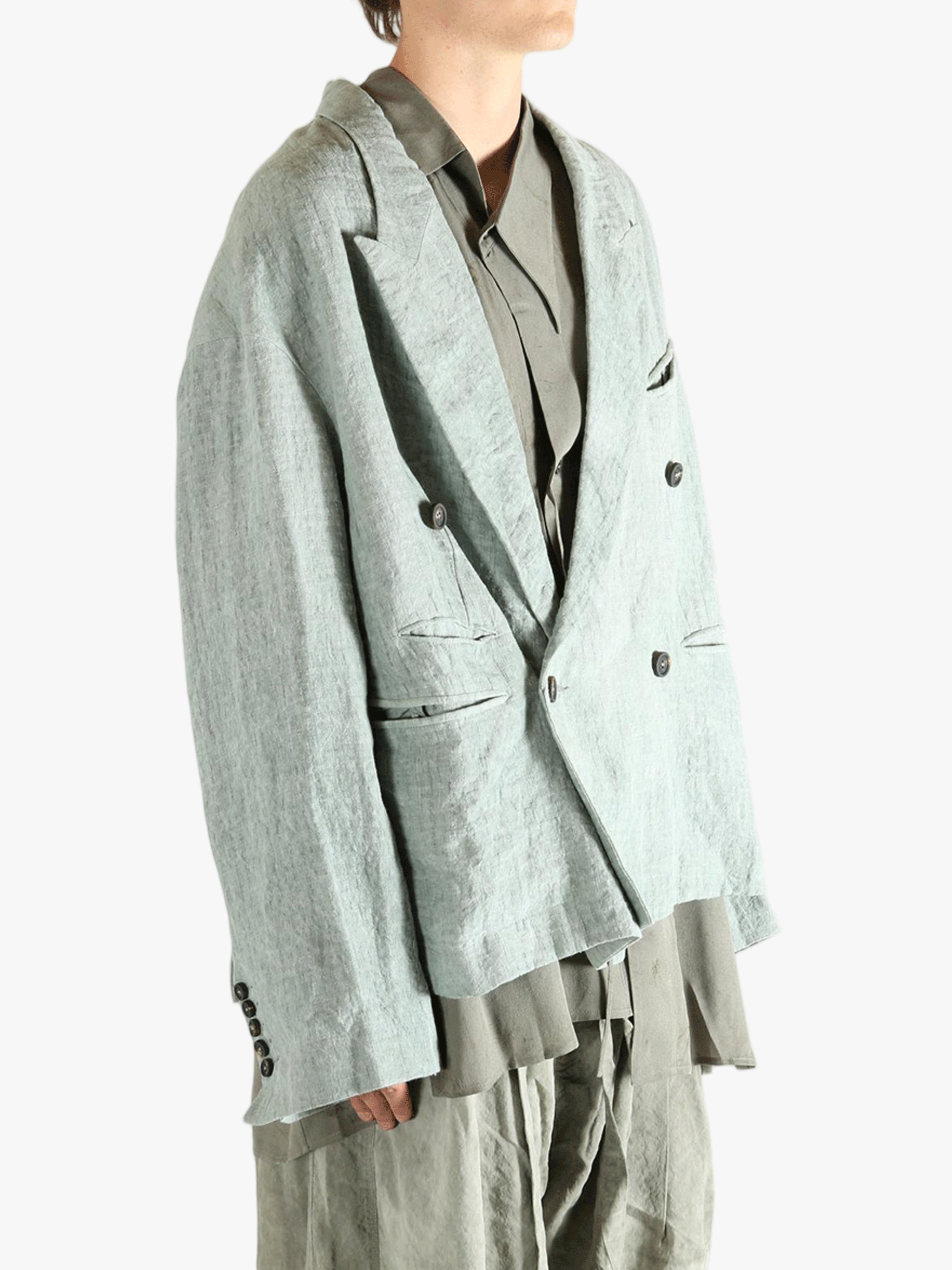 Grey jackets worn by a person, showing the jackets fit